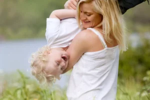 mother and son wrestling and laughing as mom speaks her child's love language