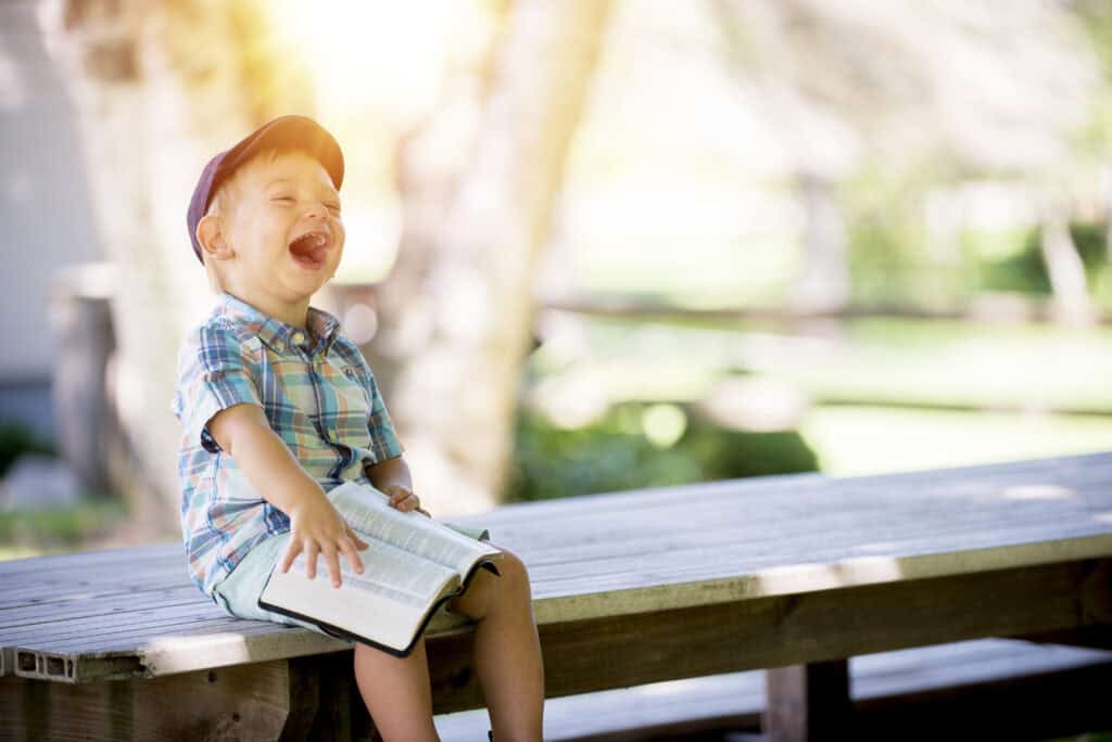 happy boy holding Bible
