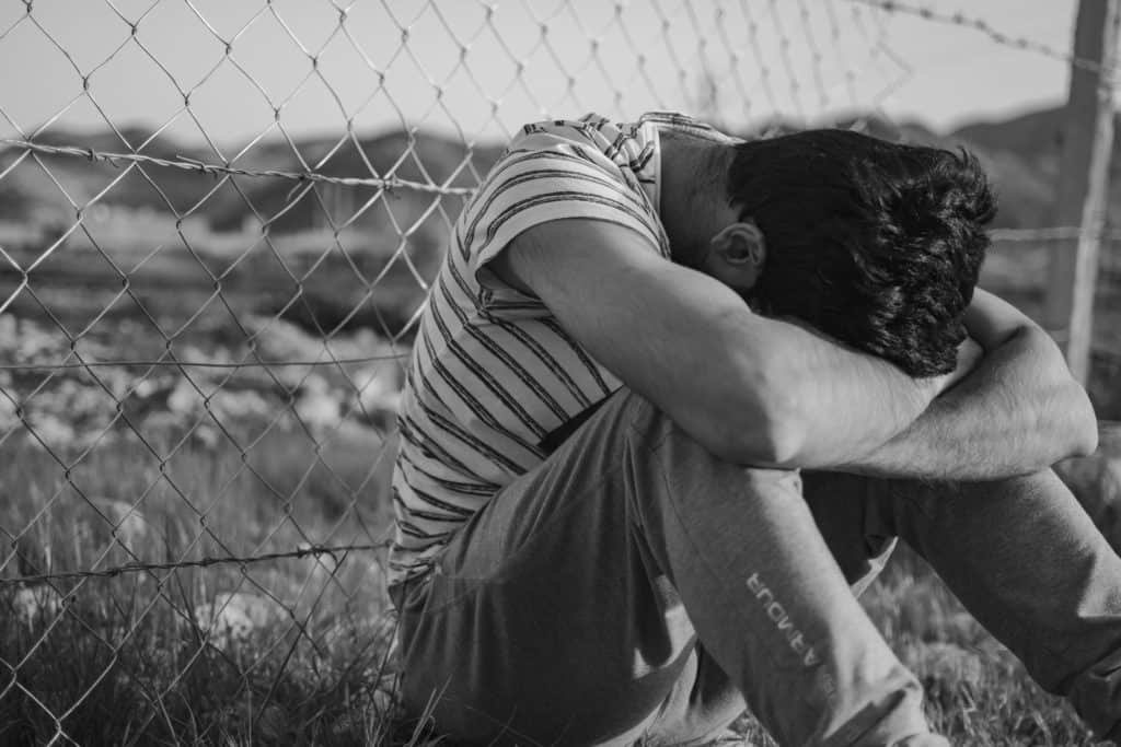 teen with head on arms