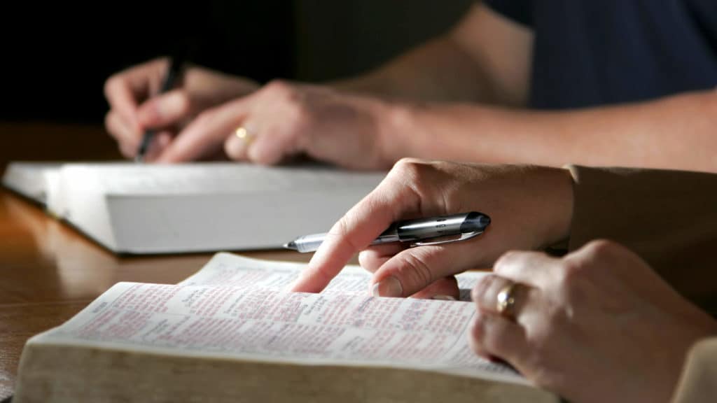 a man and woman study the Bible