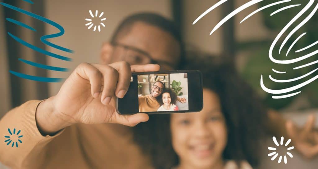 Dad and daughter taking a selfie with phone