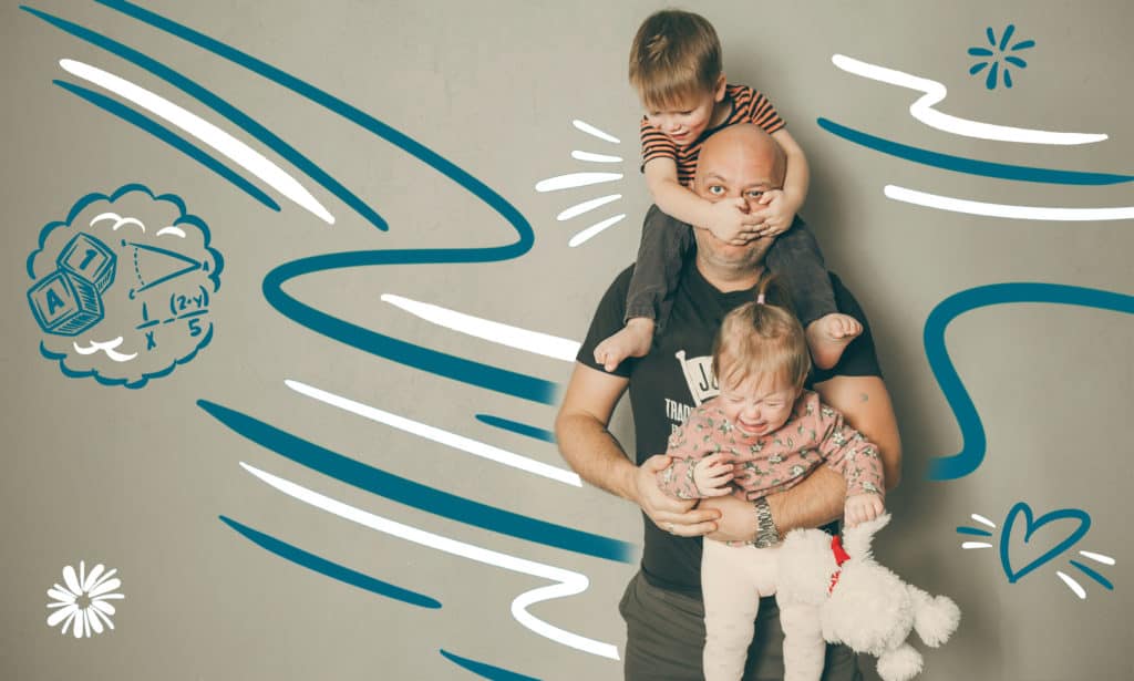 Dad trying to hang in there as he carries two kids