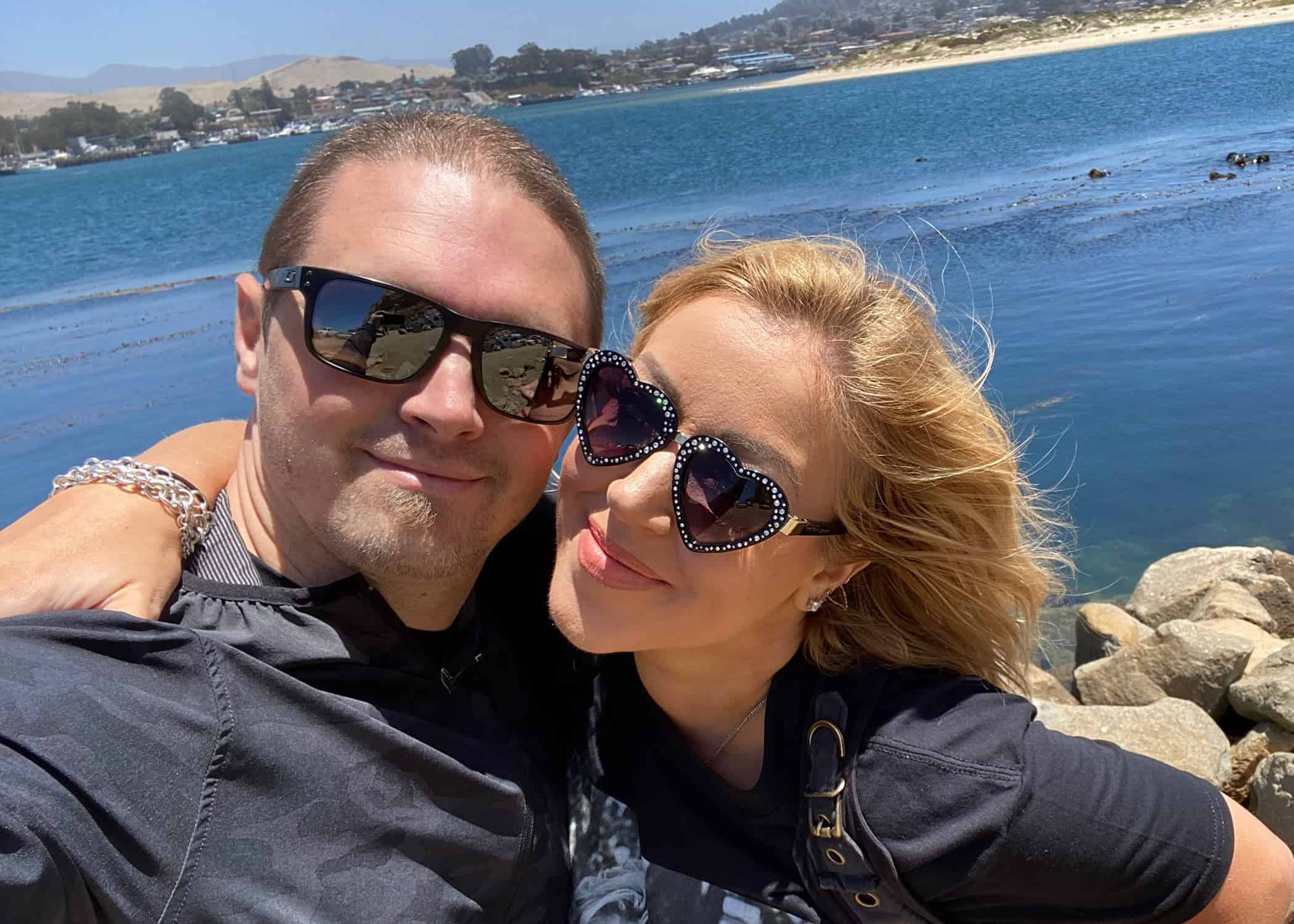 Lynsi-Snyder-Ellingson-and-husband-Sean-smiling-outside-wearing-sunglasses