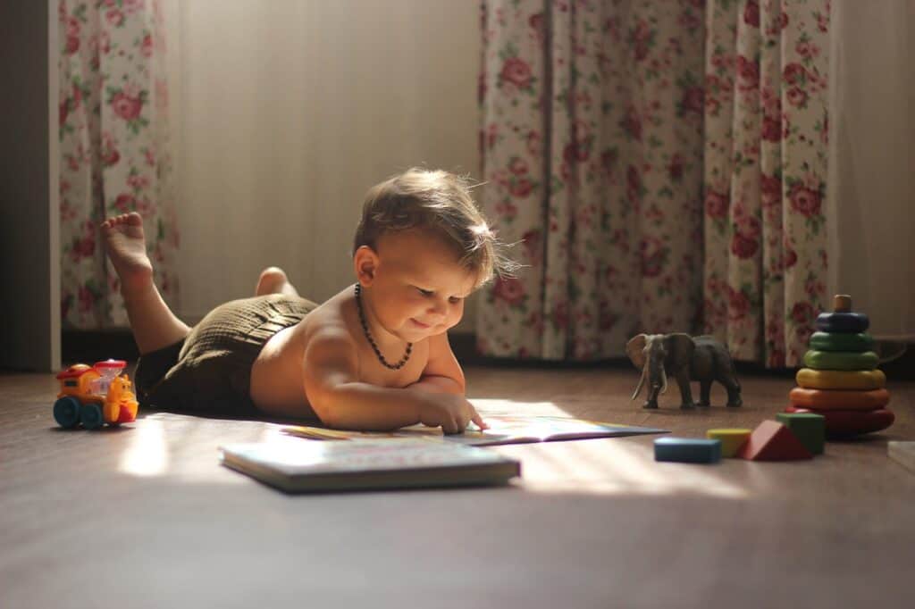 boy lying on the floor playing