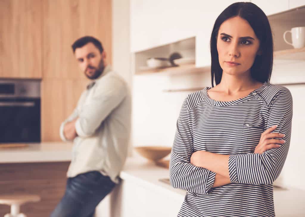 Married couple-looking-unhappy-with-each-other-with-arms-folded