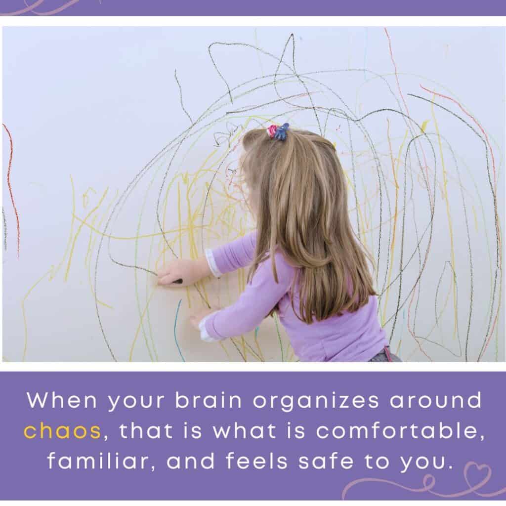A young girl scribbles on a wall filled with chaotic crayon marks, visually symbolizing how childhood trauma can shape responses to teenage drama.